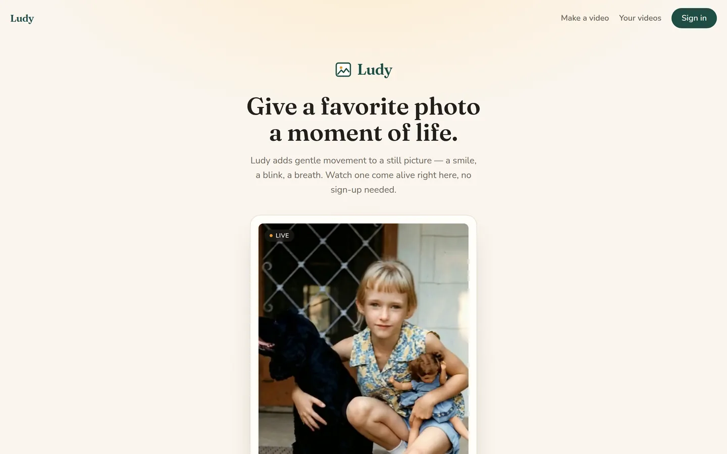 The HeyLudy home page: a vintage photo of a child with a black dog, marked live, under the line “Give a favorite photo a moment of life.”